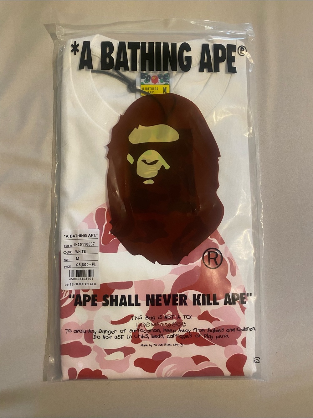 A Bathing Ape Men’s White Short Sleeve Tee with Pink Camo Ape Graphic
